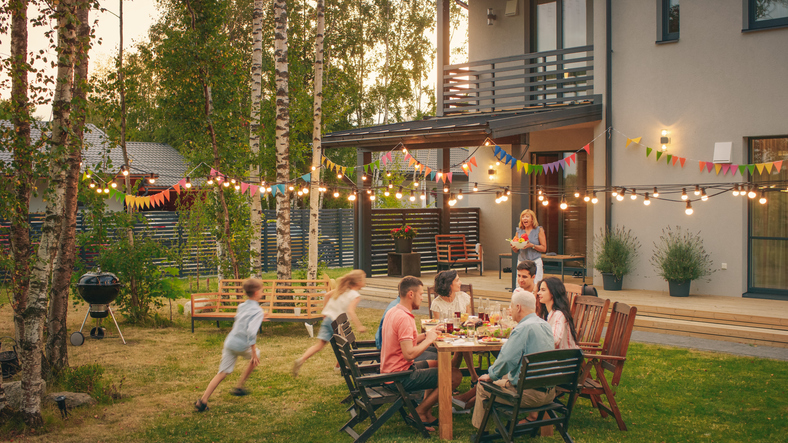 Big Family Garden Party Celebration, Gathered Together at the Table Family, Friends and Children.