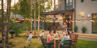 Big Family Garden Party Celebration, Gathered Together at the Table Family, Friends and Children.