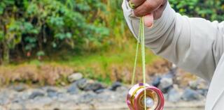 The hand figure of a man playing a yoyo
