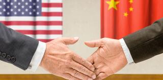 Representatives of the USA and China shake hands