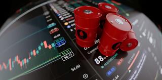Red Oil Barrels and Oil and Gas Price Charts in the screen
