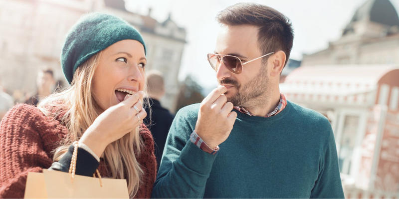 A couple enjoying a snack together.