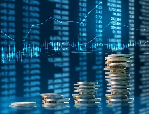 pile of coins and investing graphs
