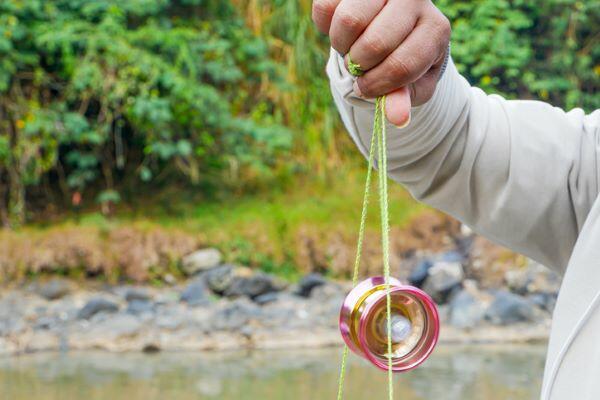 The hand figure of a man playing a yoyo