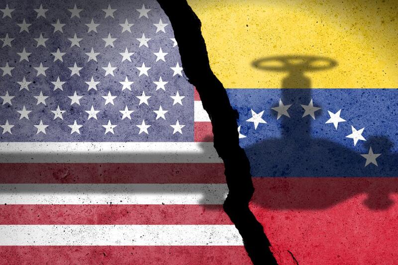 Flag of USA and Venezuela painted on a concrete wall with crude oil pipe shadow